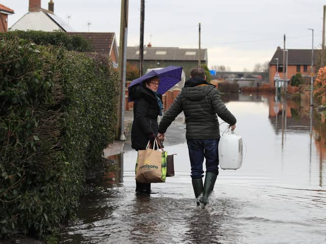 Local residents in floodwater in East Cowick, Yorkshire. Photo: Danny Lawson/PA Wire