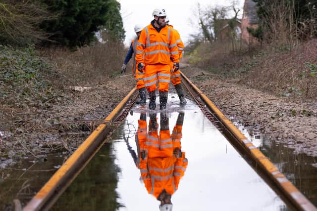 Network Rail engineers inspect a flooded railway in East Yorkshire.