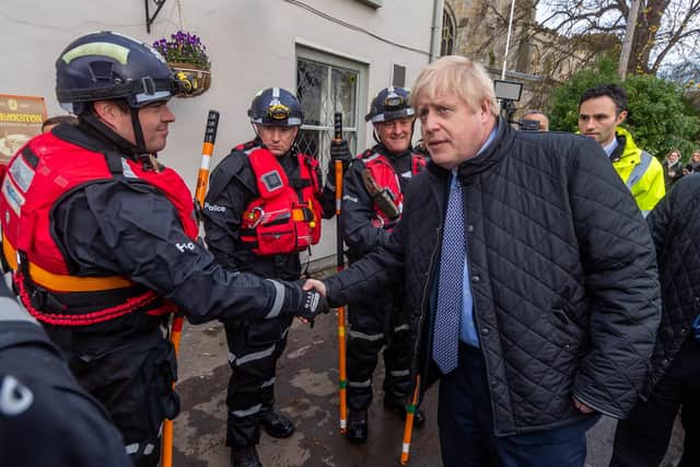 Boris Johnson thanks rescuers during a visit to Fishlake last November.
