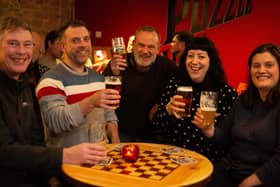 Committee members Paul Mansley, Sam Irvine, Bruce Fitzgerald, Jenny Bromley and Netty Berry celebrating the reopening as a community pub of the Puzzle Hall Inn on Hollins Mill Lane, Sowerby Bridge.