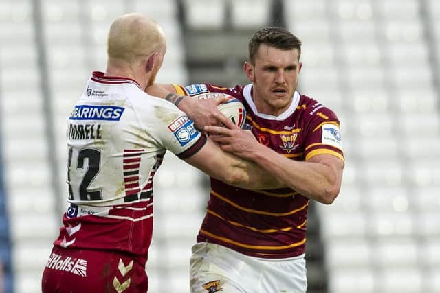 I BELIEVE: Huddersfield Giants' Lee Gaskell is tackled by Wigan's Liam Farrell last Sunday. Picture: Tony Johnson.