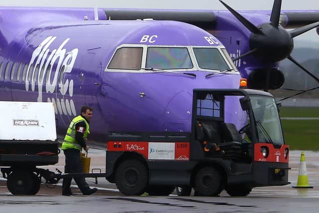 A Flybe aircraft is pictured on the tarmac at Exeter airport in south-west England on March 5, 2020, following the news that the airline had collapsed into bankruptcy. (Photo by GEOFF CADDICK / AFP)