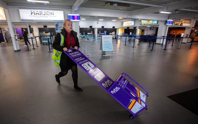A Exeter Airport member of staff removes Flybe equipment at the airport in Devon. Picture: SWNS