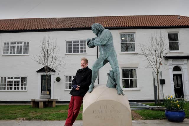 Marcus Cornish with the sculpture he was created of John Harrison at Barrow. Picture by Simon Hulme
