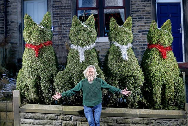 Will Worthingtonof Marsden, West Yorkshire, with the four cats he has cut out of his hedge at the front of his home. (picture Lorne Campbell / Guzelian)