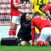 Pitching in: Barnsley physiotherapist Vikki Stevens treating Liam Lindsay. Pictures: Barnsley FC