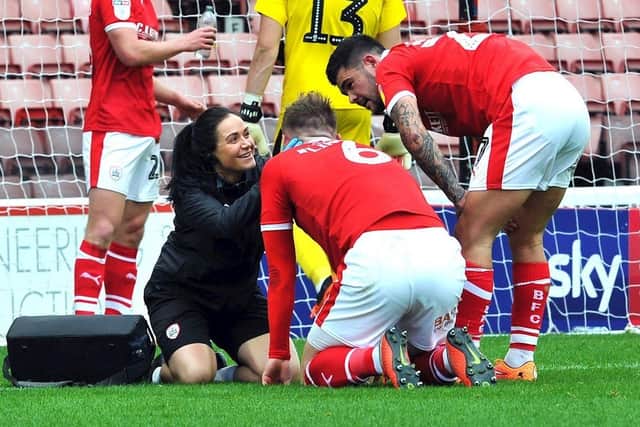 Pitching in: Barnsley physiotherapist Vikki Stevens treating Liam Lindsay. Pictures: Barnsley FC