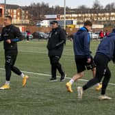 WARMING UP: Wakefield Trinity's Reece Lyne, left, in training yesterday at Dewsbury Rams' artificial pitch under the watchful guise of head coach Willie Poching. Picture: Tony Johnson.