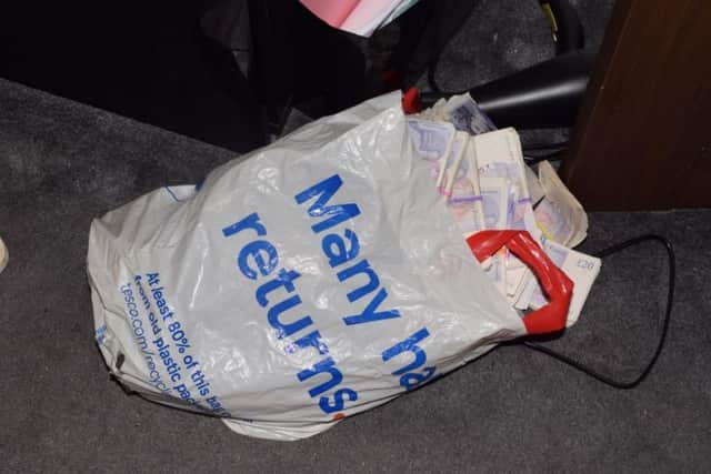 A large amount of cash was found in a Tesco carrier bag by police