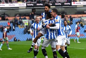 Influential substitute Sorba Thomas - who set up both of Huddersfield Town's goals - in the thick of the celebrations after the Terriers' leveller at Burnley. Picture: Jonathan Gawthorpe.