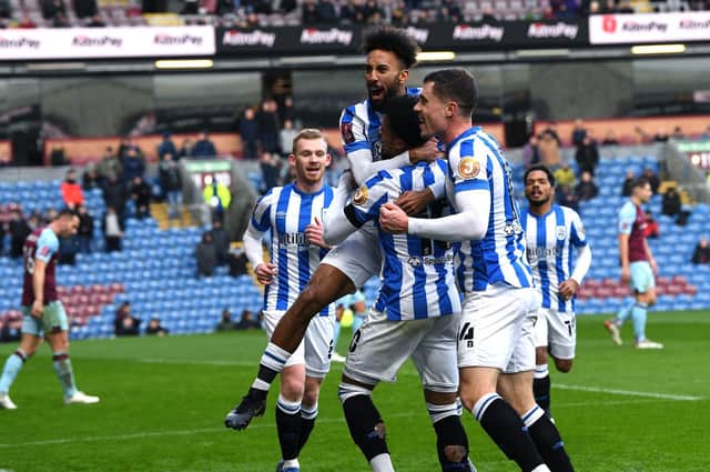 Influential substitute Sorba Thomas - who set up both of Huddersfield Town's goals - in the thick of the celebrations after the Terriers' leveller at Burnley. Picture: Jonathan Gawthorpe.