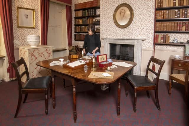 Principle curator Ann Dinsdale at the Brontë Parsonage Museum in Haworth with the dining room table which witnessed the creation of the world-famous novels, Wuthering Heights and Jane Eyre. (Picture: Tony Johnson)