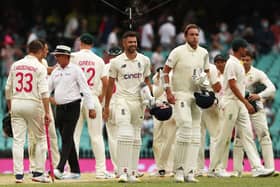 England's James Anderson and Stuart Broad celebrate after holding out for a draw in the fourth Ashes Test match in Sydney. Picture: PA.