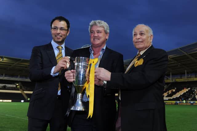 MAGIC MOMENT: Hull City manager Steve Bruce, centre, pictured with owners Ehab Allam, left and Assem Allam with the 2013 Championship runners-up trophy, celebrating the teams rise into the Premier League at the KC Stadium. Picture: Tony Johnson.