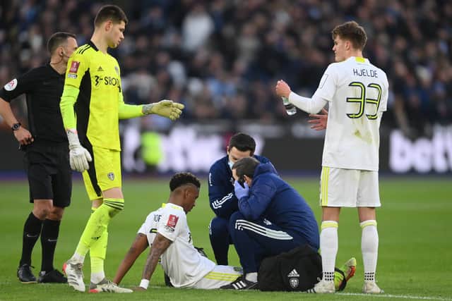 Junior Firpo of Leeds United receives medical treatment during the Emirates FA Cup match between West Ham United and Leeds United at London Stadium. (Picture: Mike Hewitt/Getty Images)