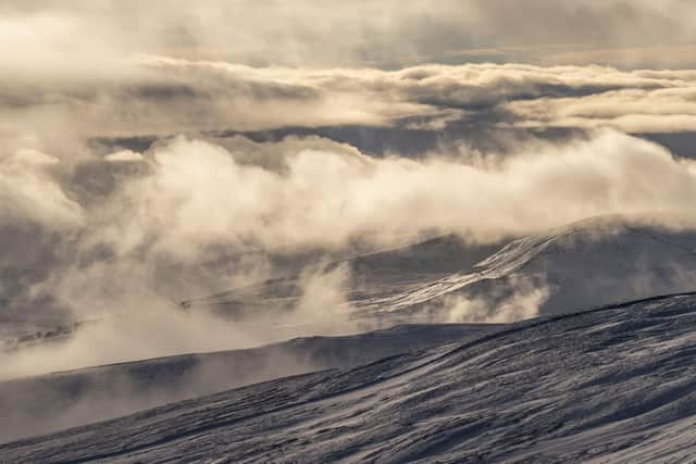 Sunlight is reflected of low clouds and the snow covered peaks in the Yorkshire Dales National Park. Image: Danny Lawson/PA wire