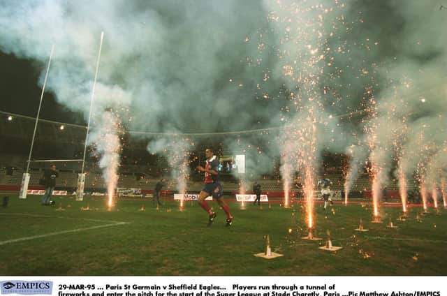 Paris SG and Sheffield Eagles players enter the pitch for the start of the first Super League season at Stade Charetly in 1996.