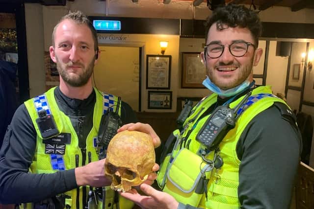 North Yorkshire Police officers return the skull