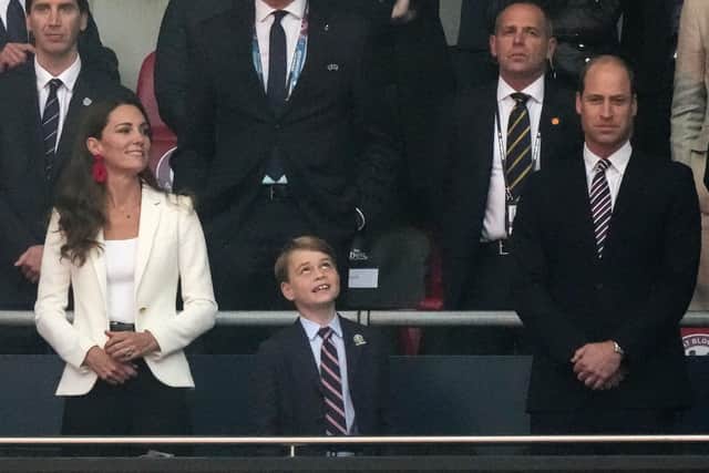 Prince George with his parents at an England football match last year - should he become Duke of York in place of the disgraced Prince Andrew?