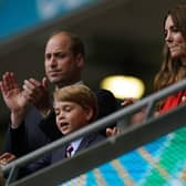 Prince George with his parents at an England football match last year - should he become Duke of York in place of the disgraced Prince Andrew?