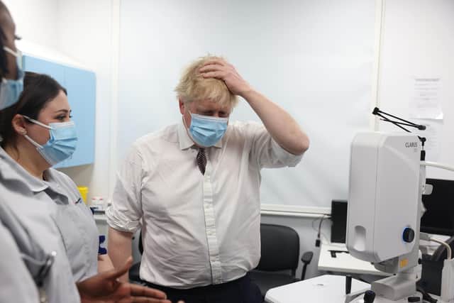 Prime Minister Boris Johnson talks to staff during a visit to the Finchley Memorial Hospital in North London where his interview with Sky News political editor Beth Rigby led to renewed questions about his premiership.
