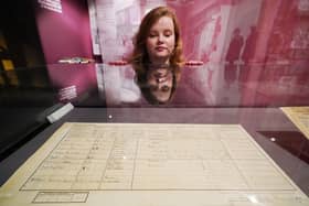 A member of staff observes the original 1921 census return for Downing Street, London, which is on display at the National Archives in Kew in London, for a new exhibition, The 1920s: Beyond the Roar. The exhibition marks the publication of the 1921 Census for England and Wales and allows visitors to explore 1920s life. (Photo: Jonathan Brady/PA Wire)
