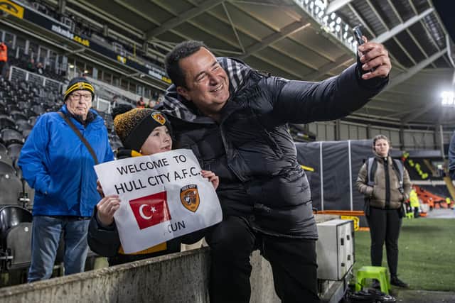 Hull's new owner Acun Ilicali welcomed to the MKM Stadium by a young fan before the match.  Picture: Tony Johnson