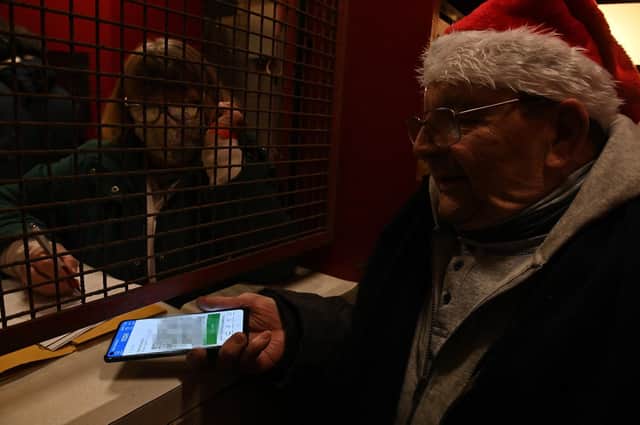 PASS: A Barnsley fan shows his Covid pass at Oakwell in December