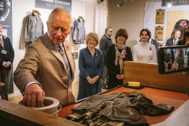 Prince Charles has a go at rewaxing a Barbour jacket at the new South Shields Wax for Life Workshop.