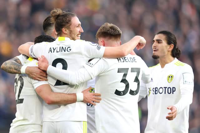Jack Harrison (obscured) celebrates with teammates Luke Ayling and Leo Hjelde of Leeds United after scoring their team's second goal during the Premier League match between West Ham United and Leeds United at London Stadium on January 16, 2022 in London, England. (Picture: Alex Pantling/Getty Images)