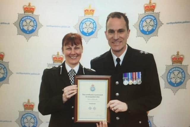 Martin receiving his Long Service award from Chief Constable Lisa Winward