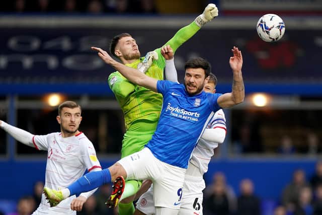 Birmingham City's Scott Hogan battles for the ball with Barnsley goalkeeper Bradley Collins (Picture: PA)