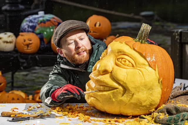 Jamie Wardley with a carving of an environmental activist created from a pumpkin. (Tony Johnson).