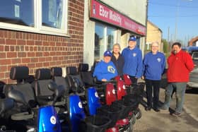 Andrew Todd (Ebor Mobility) is pictured with Pocklington Lions Club members and Jackie East (representing St Helen’s Farm).