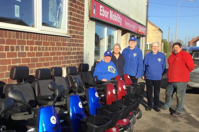 Andrew Todd (Ebor Mobility) is pictured with Pocklington Lions Club members and Jackie East (representing St Helen’s Farm).