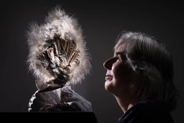 Curator Kitty Ross with a feather fan decorated with a stuffed bird, from 1860-1880 Picture: Danny Lawson/PA Wire