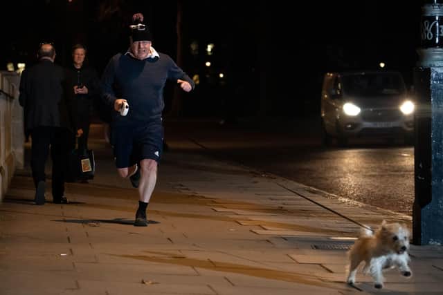 This was Boris Johnson going for an early morning job with his dog Dilyn yesterday before the Sue Gray report was published.
