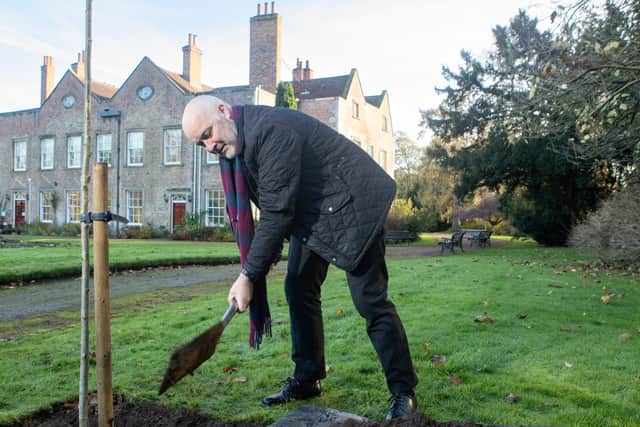 The Archbishop of York planting a tree at Bishopthorpe Palace.