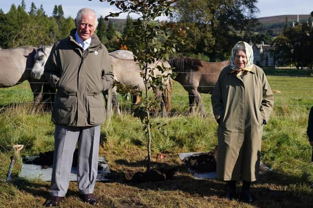 The Queen and Prince of Wales with a tree they planted at the Balmoral Cricket Pavilion to mark the start of the official planting season for the Queen's Green Canopy (QGC) in honour of the Platinum Jubilee.