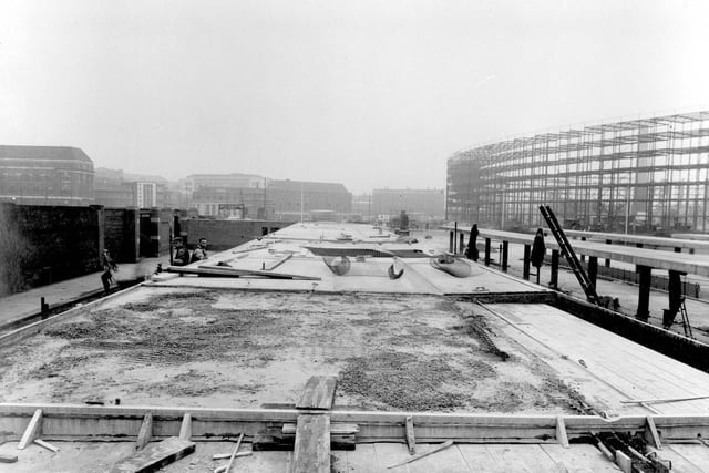 Construction work on new bus station in July 1938. Quarry Hill Flats building in on the right, skeleton framework can be seen