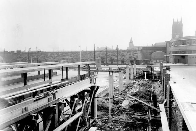 Construction of central bus station, looking towards York Street. The railway embankment and viaduct can be seen with Leeds Parish Church behind.