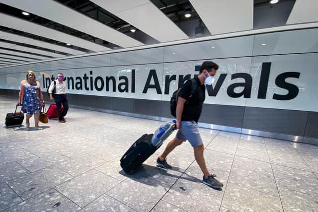Library image of passengers in the arrivals hall at Heathrow Airport