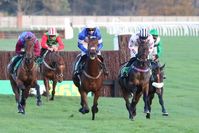 Aye Right and Callum Bewley (right) lead Harry Cobden on eventual winner Cyrname in the 2020 Charlie Hall Chase at Wetherby. Photo: Phill Andrews.