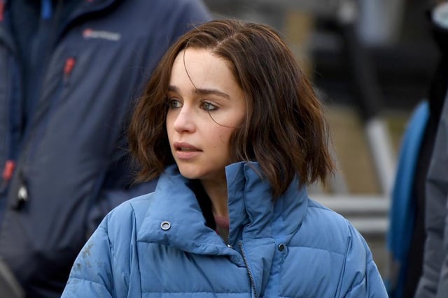 Emilia Clarke gets wrapped up warm as she waits between takes at filming in Halifax today. Photo by Getty Images.