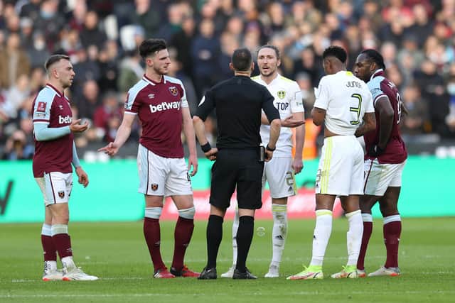 Luke Ayling of Leeds United and Declan Rice and Jarrod Bowen of West Ham United speak with referee Stuart Attwell as VAR looks at West Ham United's first goal during the FA Cup Third Round match at London Stadium on January 9. Picture: Alex Pantling/Getty Images