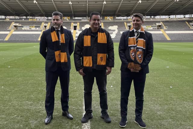 Hull City CEO Jim Rodwell, chairman Acun Ilicali, and vice-chairman Tan Kesler (left-right) pose for pictures on the pitch.