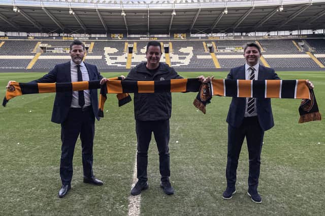 Hull City CEO Jim Rodwell, chairman Acun Ilicali, and vice-chairman Tan Kesler (left-right) pose for pictures on the pitch at the MKM Stadium. Picture: Simon Peach/PA