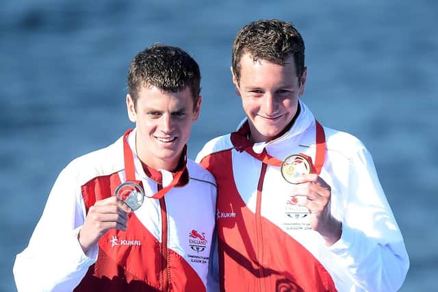 England's Alistair Brownlee (right) celebrates with his gold medal after winning the men's triathlon with brother Jonathan who took silver, at Strathclyde Country Park during the 2014 Commonwealth Games near Glasgow. (Picture: PA)