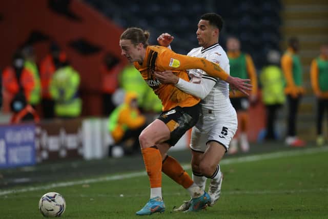 Hull City's Tom Eaves (left) and Swansea City's Ben Cabango battle for the ball (Pictures: Ian Hodgson/PA)