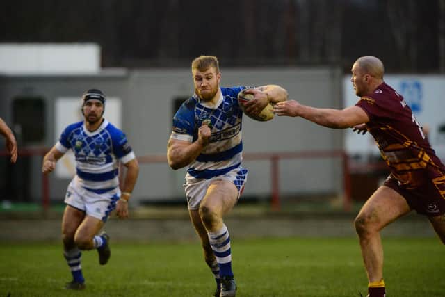 No escape: Halifax's Dan Murray is tackled by Lucas Walshaw of Batley Bulldogs. Picture: Tony Johnson